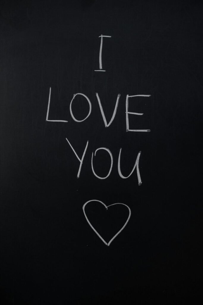 A simple 'I Love You' handwritten on a chalkboard with a heart symbol.